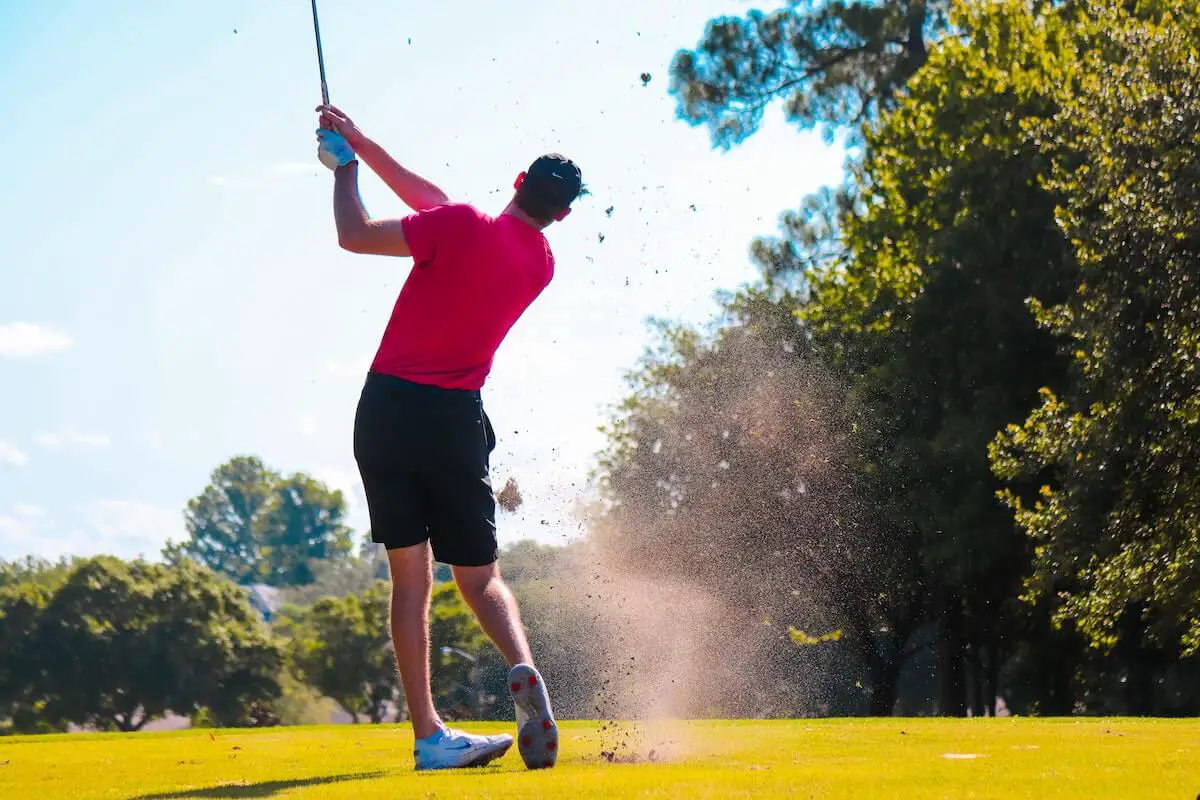 golfer swinging an iron